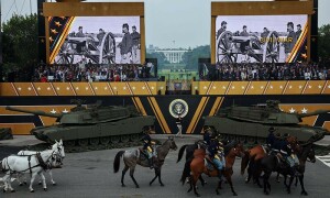 Trump flexes military might at parade as protests sweep US