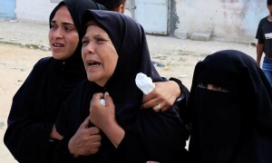 PHOTOS: Mourners react during the funeral of a Palestinian killed by Israeli fire near a distribution centre