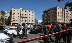 PHOTOS: Emergency services work at the site of the an Iranian missile attack near Tel Aviv
