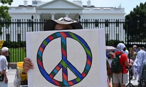 PHOTOS: People hold signs as they demonstrate outside the White House against US strikes on Iran