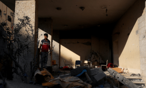 PHOTOS: Displaced Palestinians inspect damages after overnight strike on Gaza shelter
