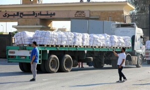 PHOTOS: Humanitarian aid trucks await permission on Egyptian side of Rafah crossing to enter Gaza Strip