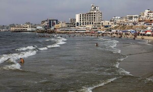 PHOTOS: Displaced Palestinians cool off in the seawater amid summer heat in Gaza City