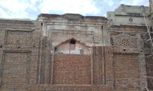 Century-old historic structures obscured by new walls in Chakwal