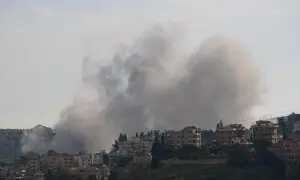 PHOTOS: Rescuers clear debris following Israeli strikes on southern Lebanese town