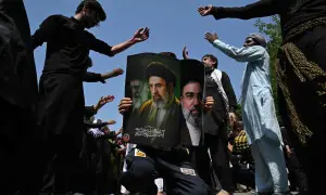 PHOTOS: Pakistanis hold posters of Iranian supreme leaders during Muharram procession