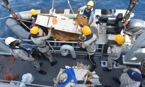 Families of crew aboard crashed cargo plane face agonising wait