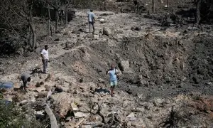 PHOTOS: People examine crater left by Israeli strike in southern Lebanon