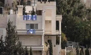Israeli flags hang from a house after the Israeli army forced Palestinians to evacuate the Ein Deir Baha neighborhood in occupied West Bank city of Hebron on Oct 24, 2026. — AFP
