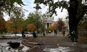 Street cleaning workers clear away the remains of tents and rubbish from a pro-government encampment in a park opposite the Serbian Parliament in Belgrade on Oct 26, 2026, after crowds celebrating election results entered the site the previous night and dismantled tents that had occupied the area for months, setting them alight along with a number of cars. — AFP
