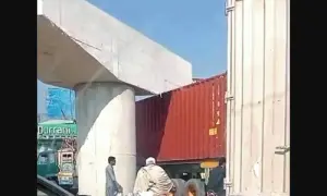 Container truck gets stuck under flyover pier in Charsadda